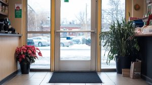 A front door with a black floor mat